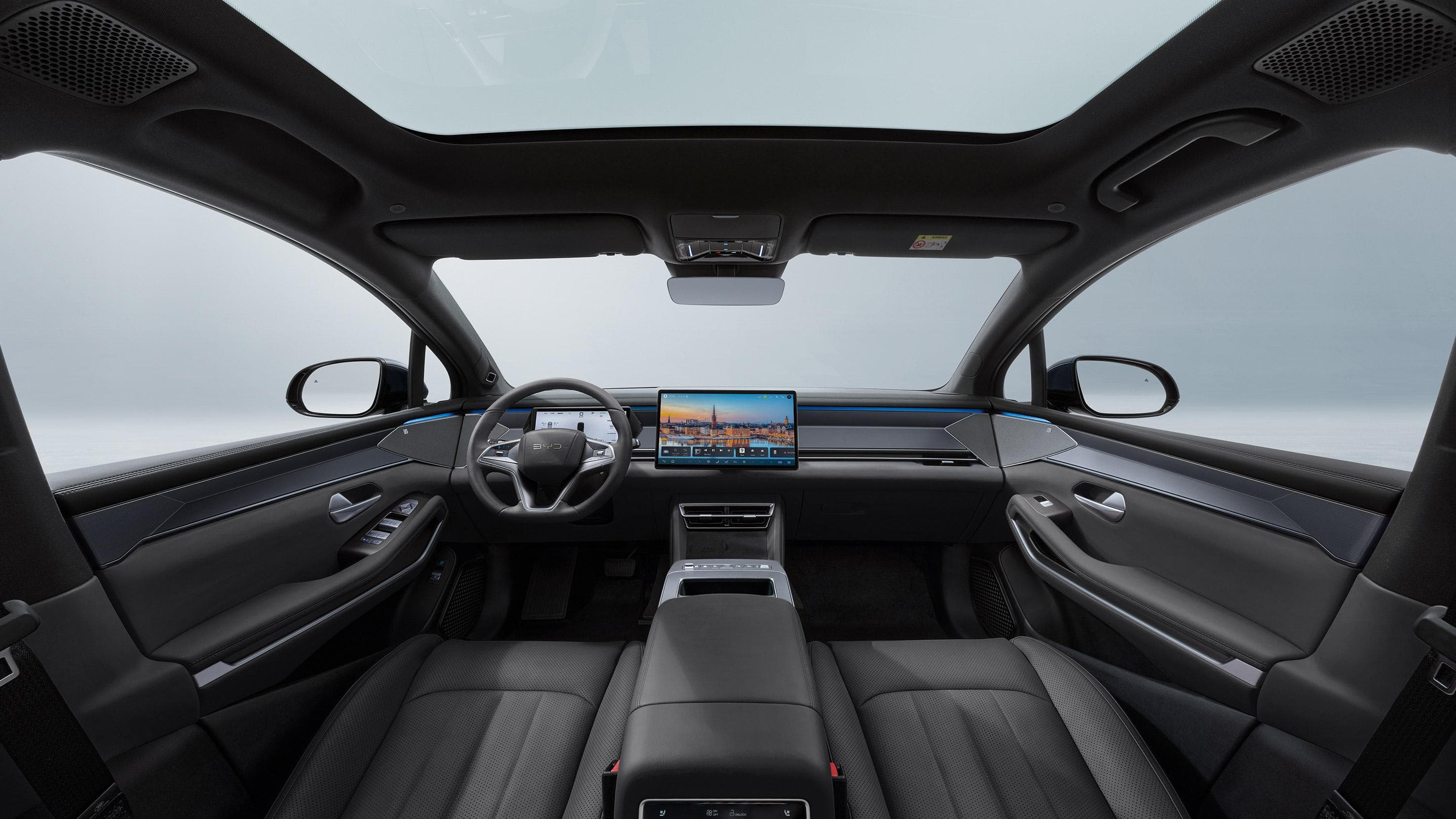 BYD Atto 8 interior featuring a 15.6-inch touchscreen, digital instrument cluster and panoramic glass roof.