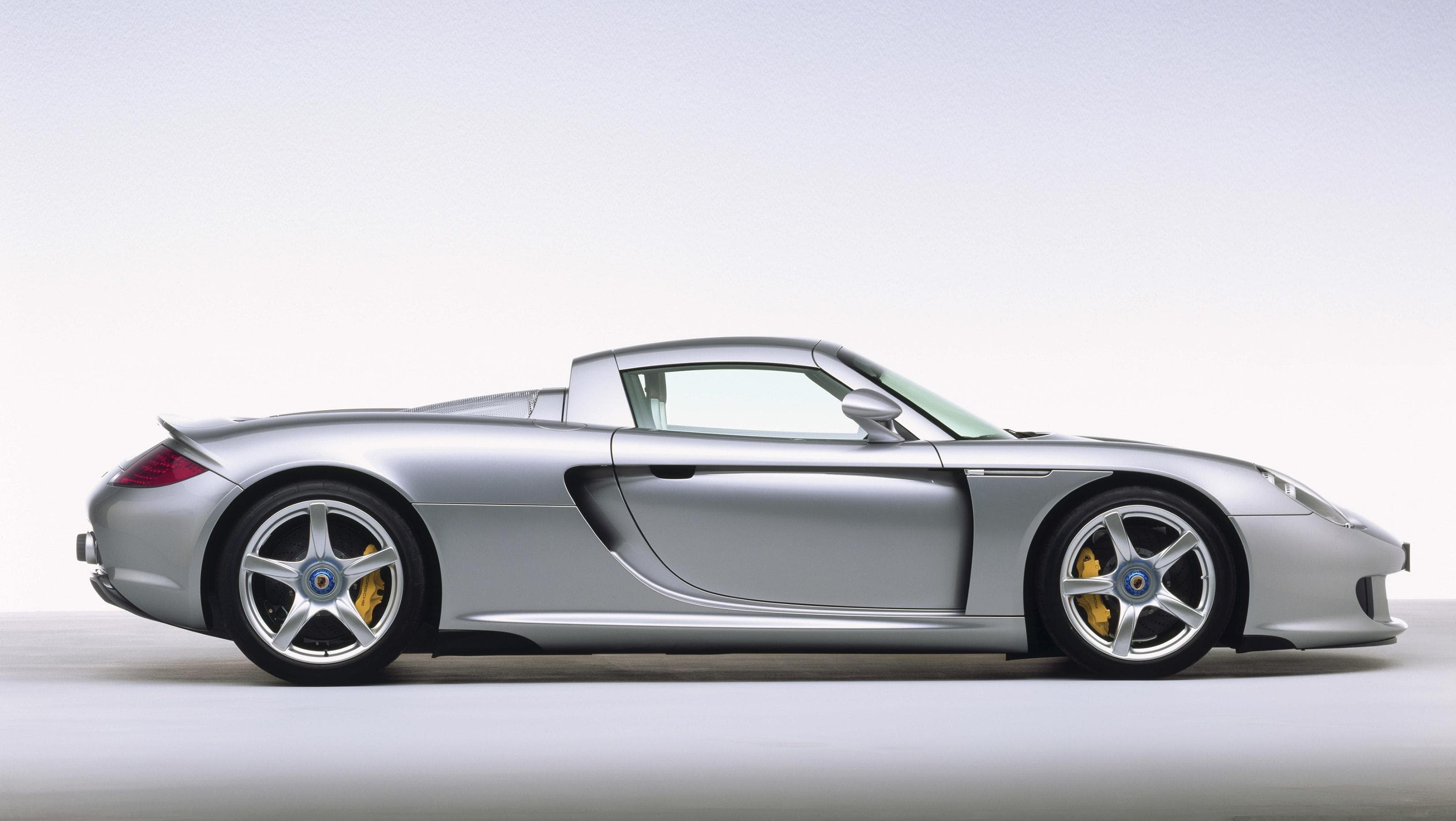 Silver Porsche Carrera GT mid-engined V10 supercar, a potential spiritual predecessor to the Mission S.